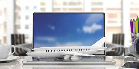 Online booking. Airplane on a computer laptop, front view, blur office background. 3d illustrationの写真素材