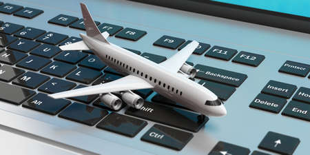 Online booking. Airplane isolated on a computer keyboard, above view. 3d illustration