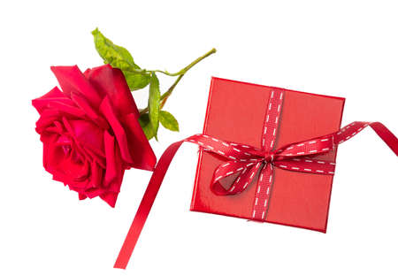 Valentines day. Rose red flower with green leaves and a red gift leather box isolated on a white background, top viewの写真素材