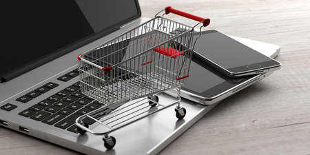 Online shopping concept. Shopping cart, smartphone, tablet and a computer laptop, on wooden...
