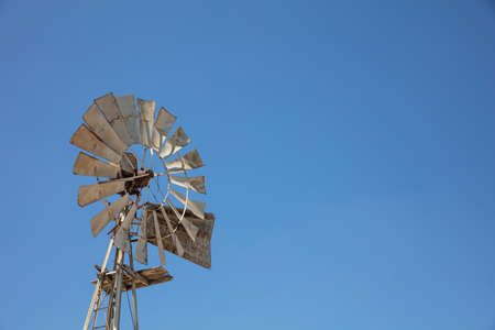 Multi-bladed windpump on blue sky background, text for spaceの写真素材