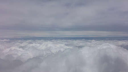 Cloudy sky background. View out of a plane window.