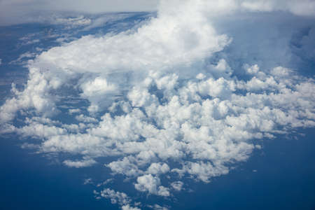 Cloudy sky background. View out of a plane window.