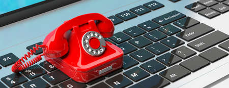 Red old retro telephone on computer laptop keyboard. 3d illustration