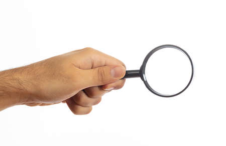 Search concept. Magnifying glass on a male hand palm isolated on white backgroundの写真素材