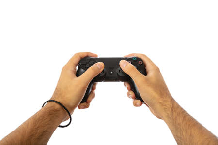 Playing video games. Male hands holding a video game controller isolated on white background, clipping pathの写真素材