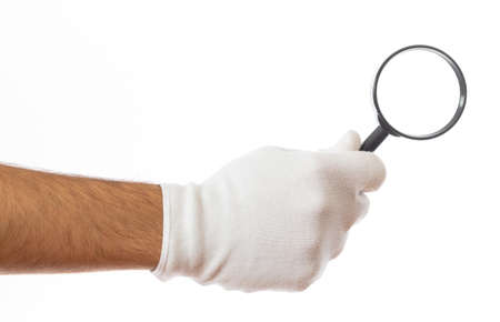 Search concept. Magnifying glass on a gloved male hand palm isolated on white backgroundの写真素材