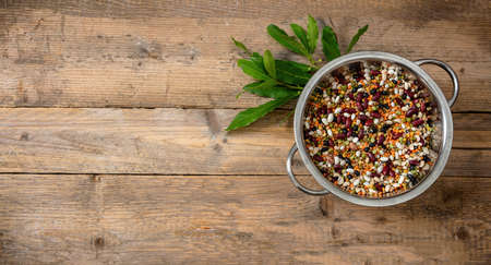 Healthy diet concept.  Assortment of legumes in a pot on a wooden tabletop background, isolated, top view, copy space.の写真素材