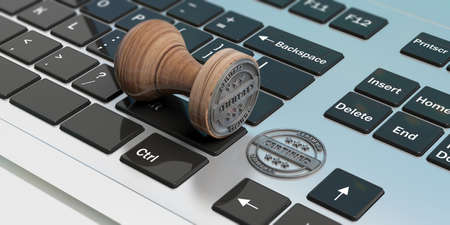 CERTIFIED stamp. Wooden round stamper and stamp with text certified on a computer laptop. 3d illustrationの写真素材