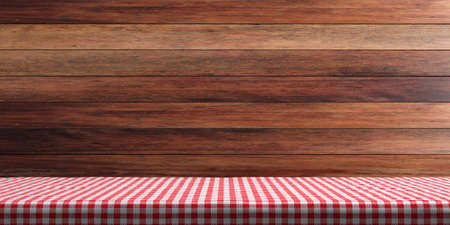 Table covered with red checkered tablecloth on wooden wall background, copy space. 3d illustrationの写真素材