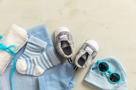 Baby boy shower concept on wooden background, copy space, top view