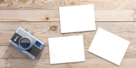 Vintage concept. Top view of isolated retro camera and blank photos on wooden background, copy space, 3d illustration.の写真素材