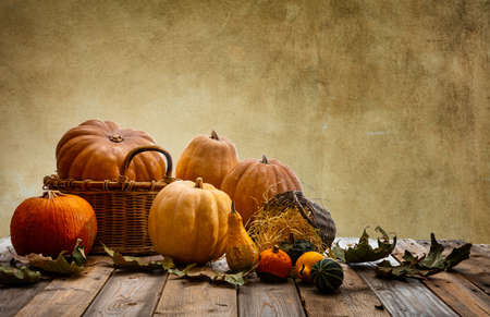 Thanksgiving concept. Colorful pumpkins and fall leaves on rustic wooden table, copy spaceの写真素材