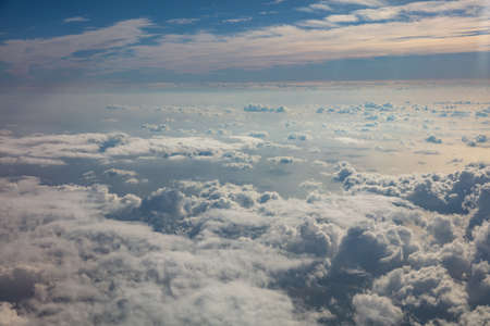 Cloudscape background. View from above, out of an airplane window.