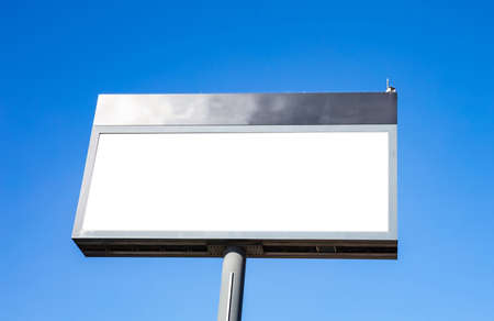 Blank billboard mockup for advertising in city, blue sky background