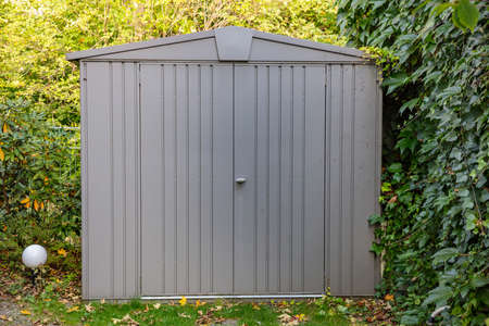 Gardening tools storage shed in the house backyard, autumn nature backgroundの写真素材