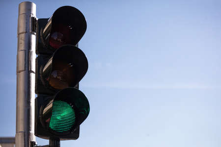 Green traffic lights for cars, blue sky background, copy spaceの写真素材