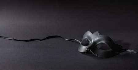 Carnival time. Venetian mask on black background, banner, copy spaceの写真素材