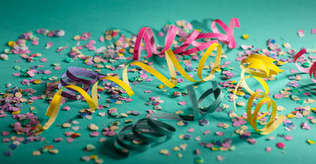 Carnival or birthday party. Confetti and serpentines on bright green backgroundの写真素材