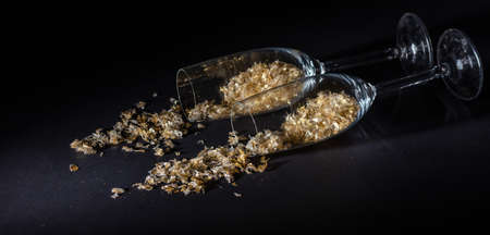 Two crystal champagne glasses on black background, copy space