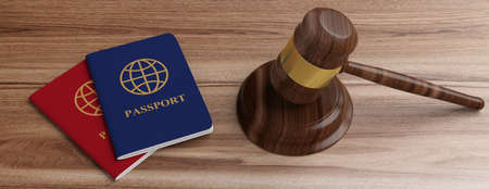 Immigration law. Two passports and a judge gavel on wooden desk background, banner. 3d illustrationの写真素材