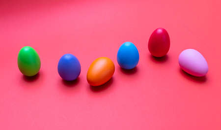 Easter eggs, pastel colors painted against orange color background