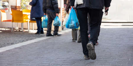 Plastic bags use. People hoding plastic bags. Closeup view, copy space