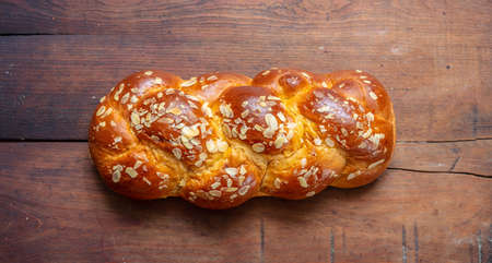 Easter preparation. Tsoureki braid, greek easter sweet bread on wood, top view
