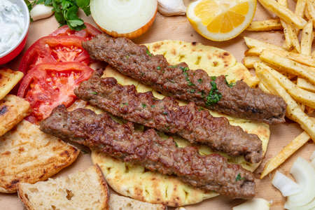 Kebab, traditional turkish, greek meat food on pita bread, tzatziki sauce and potatoes, top viewの写真素材
