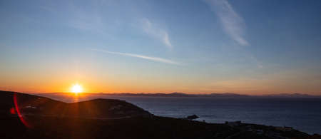 Sunset view from Kea island, Greece. Sun falling over Attica and Aegean sea, clear blue orange color...