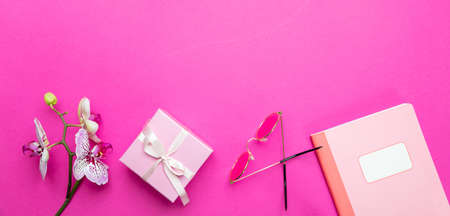 Womens day. Flowers, pink orchids and female accessories on pink desk background, copy spaceの写真素材
