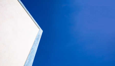 Greece white and blue colors. White building with blue details closeup view, clear blue sky background, copy spaceの写真素材