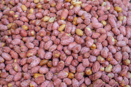 Peanuts snack salty. Red skin peanuts roasted and salted background, texture. Top viewの写真素材