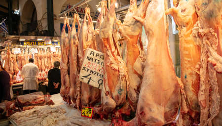 April 28, 2019. Athens, Greece. Greek meat market concept. Whole and half certified lambs are sold, out of butcher storeのeditorial素材