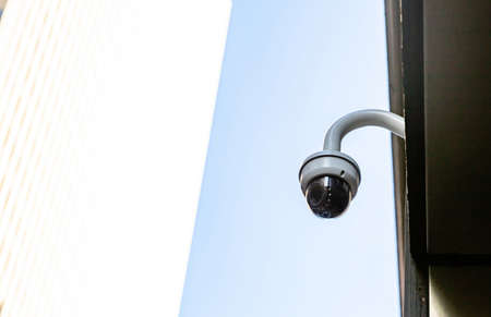 CCTV Security system. Surveillance Camera on the roof, white and blue color background, low angle...
