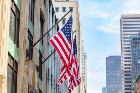 USA symbol in New York streets. American flags on a building facade, Manhattan downtown, business...