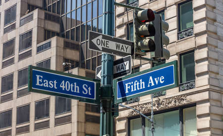 Fifth ave and East 40th crossroads street signs, Manhattan New York downtown. Blur buildings facade...