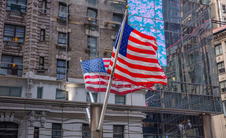 USA symbol in New York streets. American flag in Manhattan downtown, reflections on the glass