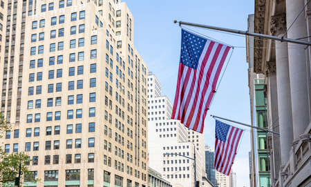 USA symbol in New York streets. American flags on a classical building, Manhattan downtown, business areaの写真素材