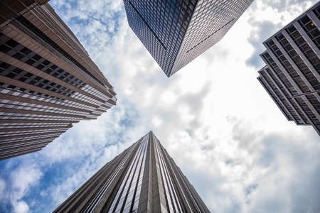 New York, Manhattan commercial center. Skyscrapers perspective view against blue sky background, low angle viewの写真素材