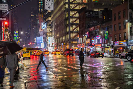 USA, New York, Manhattan. May 3, 2019. Broadway streets a rainy night. Illuminated buildings,...