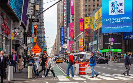 USA, New York, Times Square. May 2, 2019. High modern buildings, colorful neon lights, large commercial ads, cars and people in a spring dayのeditorial素材