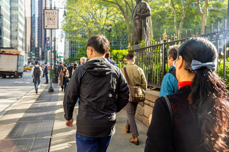 USA, New York, Manhattan downtown. May 6, 2019. Crowded streets, busy people walking in a spring...