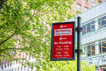 New York, USA. May 2, 2019. No parking, no standing red color sign on metal pole, blur office buildings background. Manhattan downtownのeditorial素材