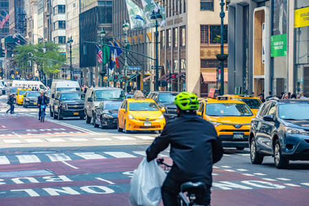 USA, New York, Manhattan streets. May 2, 2019. Skyscrapers, signs and ads, cars and taxi cabs