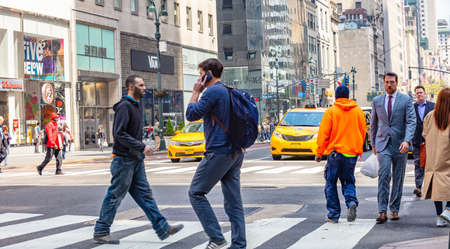 USA, New York, Manhattan streets. May 2, 2019. Skyscrapers, cars and people crossing the streetのeditorial素材