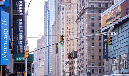 New York, USA. May 2nd, 2019. Green traffic lights for cars hanging in the city center, High office buildings backgroundのeditorial素材
