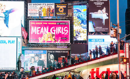 USA, New York, Manhattan. May 3, 2019. Times square at night. Colorful large ads and people waiting for the shows ticketsのeditorial素材