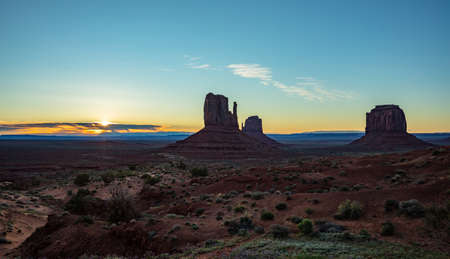 Monument Valley at sunrise. Navajo Tribal Park in the Arizona-Utah border USA. Sun rising behind the...
