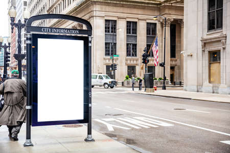 Blank white ad billboard at bus stop for advertising, Chicago city buildings and street background. Copy spaceの写真素材